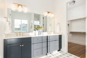 Bathroom featuring hardwood / wood-style floors and double vanity