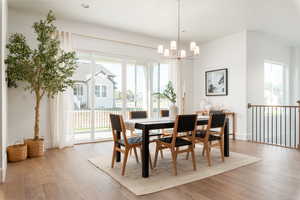 Dining area with an inviting chandelier and light hardwood / wood-style floors