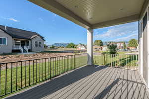 Deck with a lawn and a mountain view