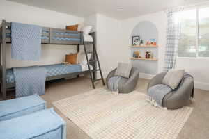 Bedroom featuring light colored carpet