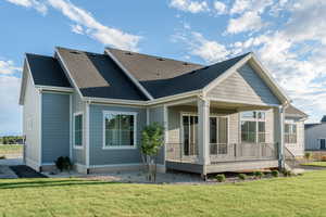 Rear view of property with a yard