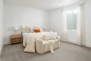 Bedroom featuring carpet floors and multiple windows