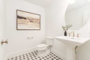 Bathroom featuring toilet and tile patterned flooring