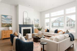 Living room featuring a stone fireplace and hardwood / wood-style floors