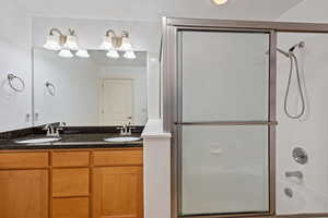 Main bathroom with double sinks oversized tub/shower.