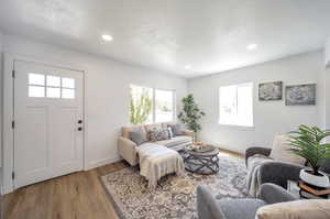 Living room with plenty of natural light and light hardwood / wood-style floors