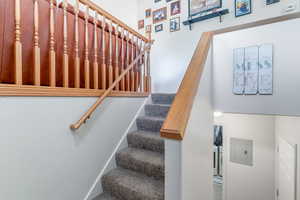 Stairway with electric panel and a high ceiling