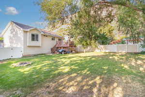 View of yard with a wooden deck