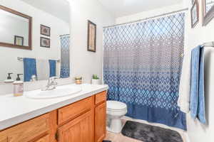 Bathroom with vanity, tile patterned flooring, and toilet