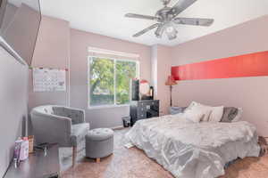 Carpeted bedroom with ceiling fan