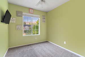 Spare room with carpet floors and ceiling fan