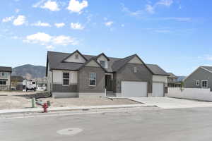 View of front of house featuring a mountain view and a garage