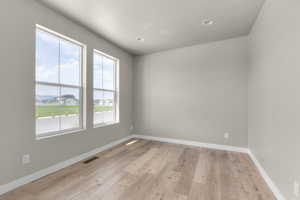 Empty room with light wood-type flooring