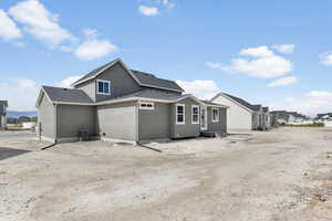 Rear view of house featuring central AC unit