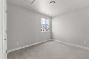 Unfurnished room featuring light colored carpet