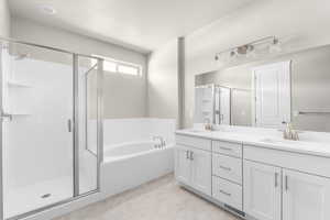 Bathroom featuring vanity and plus walk in shower