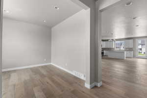 Spare room featuring a notable chandelier and light hardwood / wood-style flooring