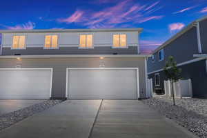 View of front of house featuring central air condition unit and a garage