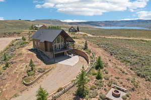 Drone / aerial view featuring a water and mountain view