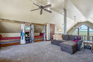 Living room with vaulted ceiling, ceiling fan, and carpet floors