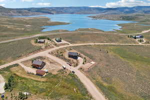 Birds eye view of property with a water and mountain view