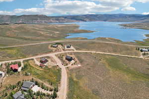 Birds eye view of property with a water and mountain view