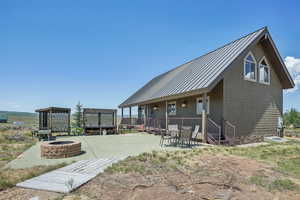 Exterior space with a patio and an outdoor fire pit