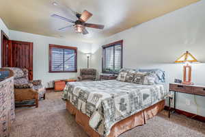 Bedroom featuring ceiling fan and light colored carpet