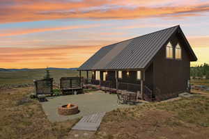 View of front facade with a mountain view and an outdoor fire pit