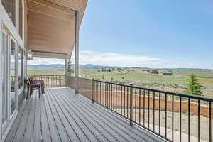 Wooden deck with a rural view and a mountain view