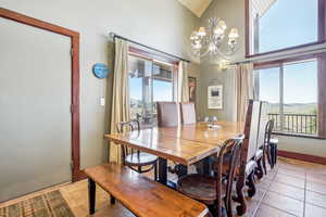 Tiled dining space featuring a notable chandelier