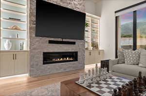 Beautiful family room featuring a large gas fireplace, beautiful cabinet book shelves.