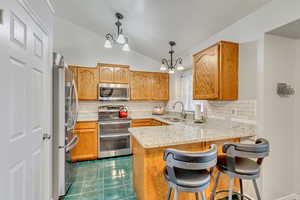 Kitchen includes granite countertops and a marble backsplash, newer microwave and dishwasher, and a double oven range.