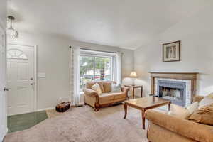 Living Room has newer carpet and a functioning wood burning fireplace!