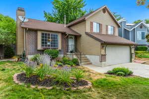 Front exterior. Home faces south.  Front flowerbed has a producing blackberry bush!