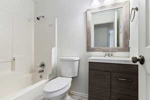 Full bathroom featuring toilet, tile patterned floors, vanity, and bathtub / shower combination