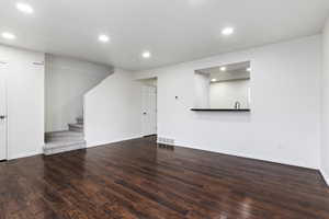 Unfurnished living room featuring hardwood / wood-style floors