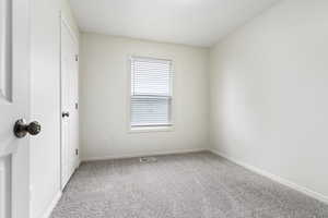 Empty room featuring carpet floors