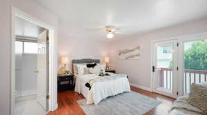 Bedroom featuring ceiling fan, access to exterior, ensuite bathroom, and laminate floors