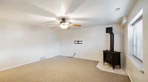 Family room with ceiling fan, light-colored carpet, and an electric stove