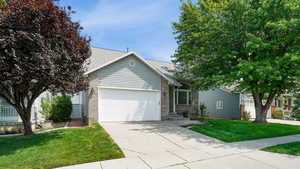 View of front of house featuring a front lawn and a garage