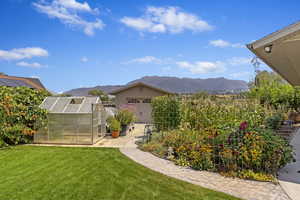 View of yard featuring a mountain view and an outbuilding