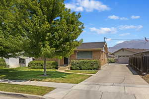 View of front of house with a front yard and a garage