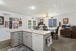 Kitchen with dishwasher, ceiling fan, sink, ornamental molding, and tile patterned flooring