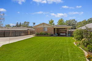 Back of house featuring a lawn and central AC unit