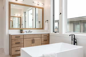 Bathroom with vanity and a tub