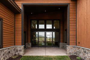 Property entrance with french doors and a patio