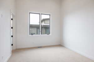 Unfurnished room with light carpet