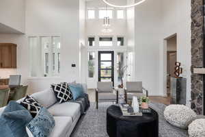 Living room with a towering ceiling and hardwood / wood-style floors