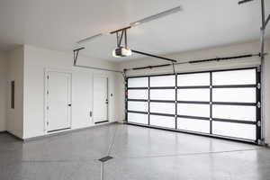 Garage featuring a garage door opener and electric panel